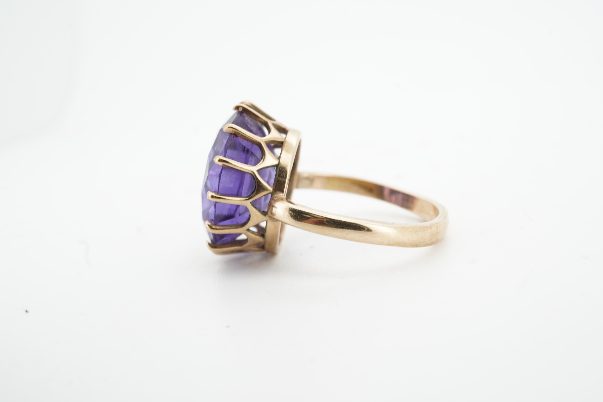A synthetic colour-change sapphire ring, claw-set with a circular-cut synthetic colour-change sapphire measuring approximately 15 x 15 x 7.9mm, mounted in gold, size H1/2